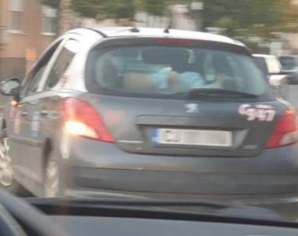 Un copil transportat pe haionul unei mașini aflate în mers