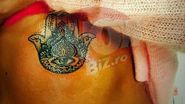 Pe abdomen i-a tatuat "hamsa" - araba, cunoscuta de musulmani drept sau "Mana Fatimei" si de crestini drept "Mana Fecioarei Maria". Iar celebrul ochi a fost inlocuit de tatuator chiar cu reproducerea ochiului stang al brunetei