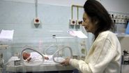 Adriana Iliescu, in urma cu zece ani, langa incubatorul unde se afla micuta Eliza, fetita sa nascuta prematur