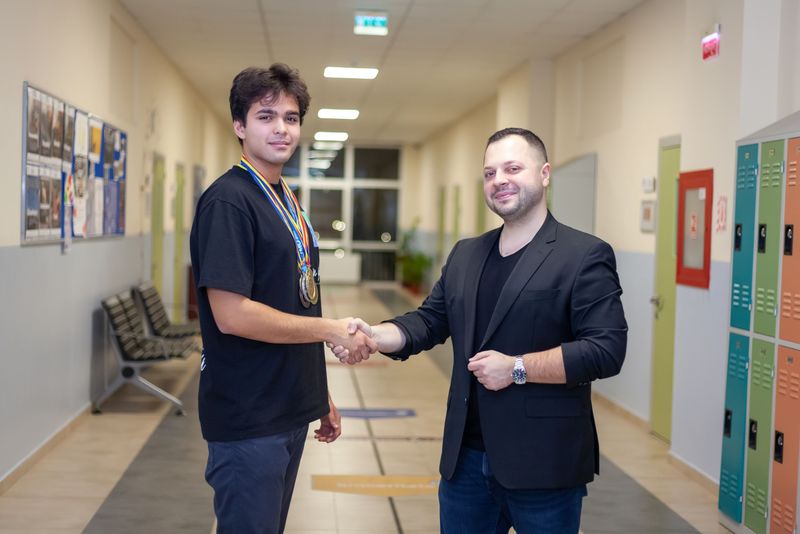 Elevul Andrei Moldovan, felicitat de profesorul de matematică Flavian Goergescu.