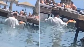 VIDEO - Un videoclip a stârnit valuri de reacții după ce în imagini apare un ospătar din Grecia care intră în apă până la mijloc pentru a servi clienții