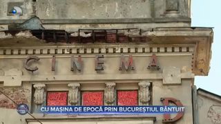 VIDEO- Cu mașini de epocă prin Bucureștiul b&acirc;ntuit. Șoferul este &icirc;mbărcat &icirc;n frac, iar pe bancheta din spate se află domnul Ioan
