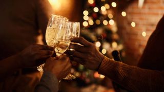 oameni care ciocnesc un pahar de sampanie de craciun