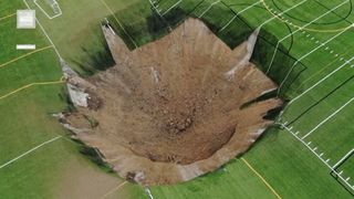 VIDEO Momentul șocant în care o gaură uriașă apare în mijlocul unui teren de fotbal