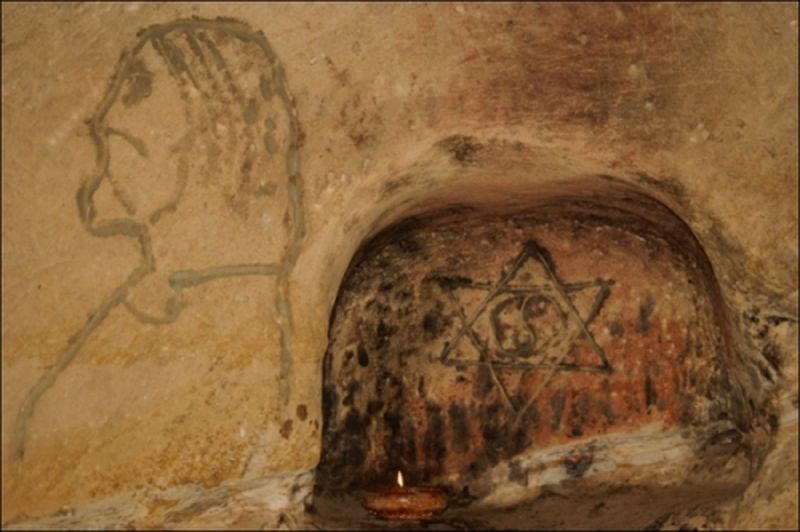 Pe un perete este desenat un chip de barbat si un semn inexplicabil: hexagrama si cercul Yin-Yang