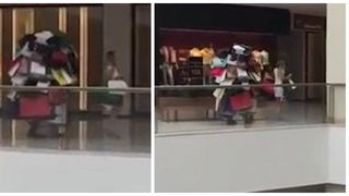 Cel mai bun sot din lume a fost surprins in mall. Ii cara sotiei un morman de pungi incat doar picioarele i se mai vad