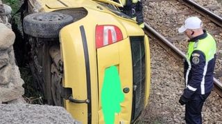 O mașină s-a răstunat pe calea ferată după ce s-a izbit violent de un alt autoturism, &icirc;n V&acirc;lcea. O persoană a fost resuscitată la fața locului